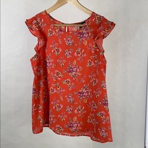 Coral top with ruffle sleeve and floral pattern
